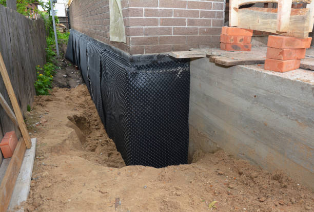 SJ Waterproofing Pros technician performing targeted Wet Basement Repair assessment in Northwood, OH